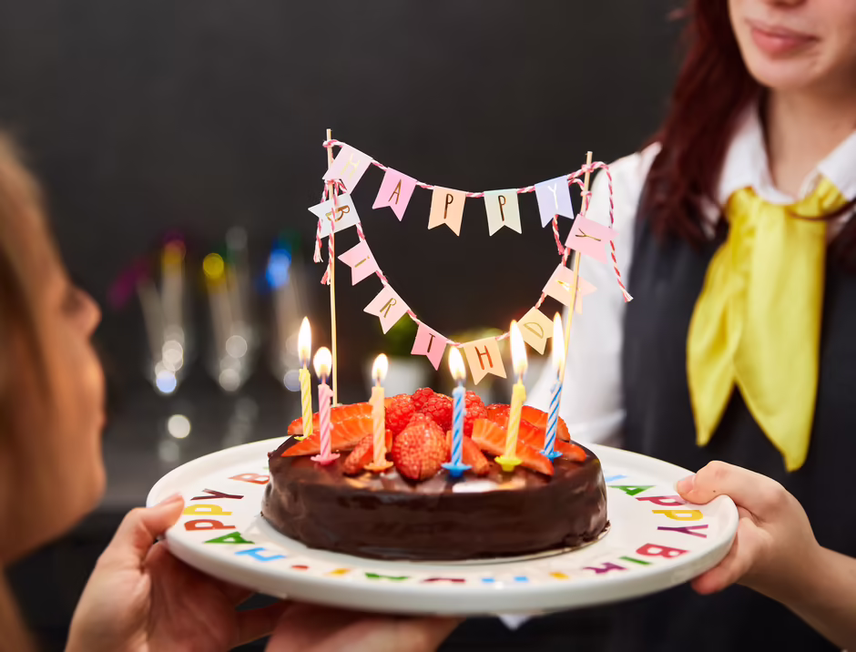 Person hält eine festlich dekorierte Torte
